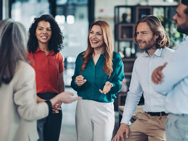 Group of professionals having a lively discussion in an office setting.