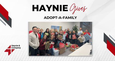 Group of people holding gifts at Haynie Adopt-a-Family event.