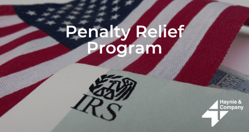 U.S. flag with IRS document and text Penalty Relief Program by Haynie.