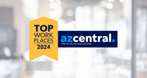 Top Workplaces 2024 award logo by azcentral on blurred office background.