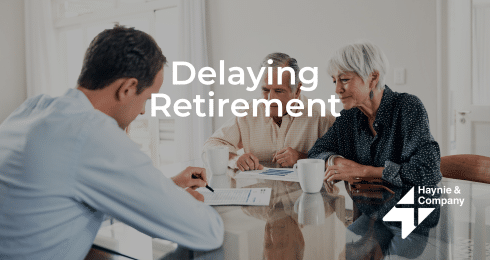 Financial advisor discussing retirement plans with an older couple at a table.