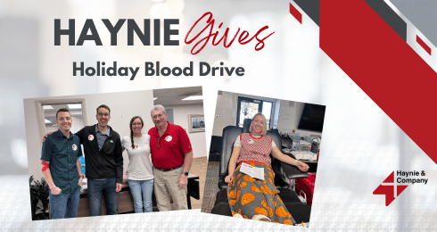 Haynie Holiday Blood Drive with group photo and donor on chair.