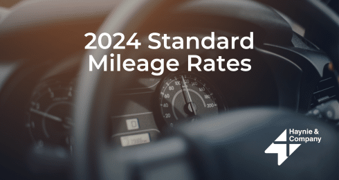 2024 Standard Mileage Rates text on image of car dashboard with Haynie logo.