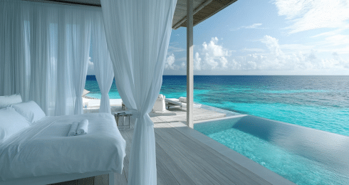 Luxurious beachfront villa with ocean view and infinity pool under clear skies. Ideal for relaxation and travel.
