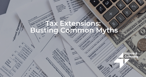 Tax forms, calculator, and cash illustrating tax extensions myths by Haynie.