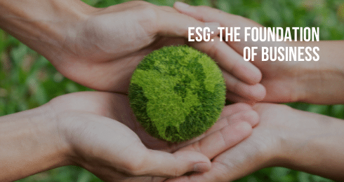 Hands supporting a globe with greenery, symbolizing ESG principles in business sustainability.
