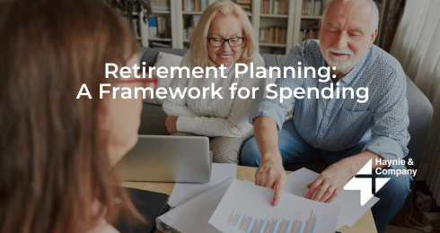 Retirement planning meeting with advisor, senior couple reviewing financial documents.