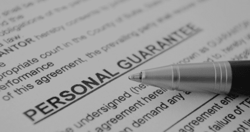 Pen on a personal guarantee document, close-up view.