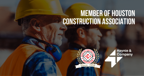 Workers in hard hats with Houston Construction Association logo and Haynie branding.