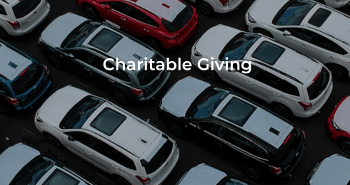 Overhead view of parked cars with the text Charitable Giving overlay.