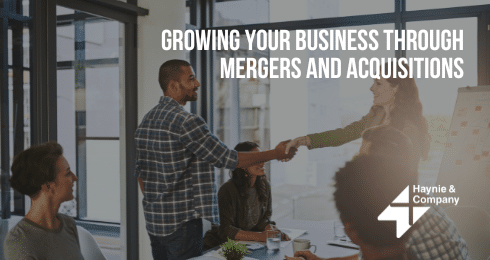 Team meeting discussing mergers and acquisitions strategy at Haynie office.