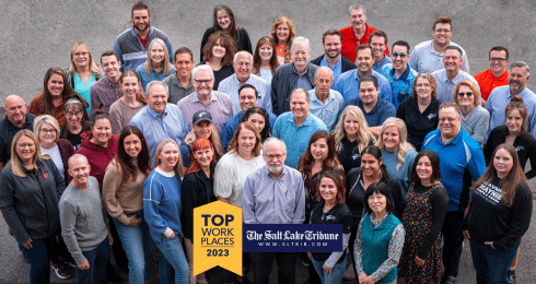 Large group of people smiling, celebrating The Salt Lake Tribune's Top Workplaces award 2023.
