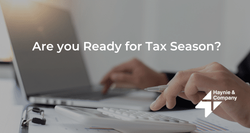 A person using a laptop and calculator, ready for tax season.