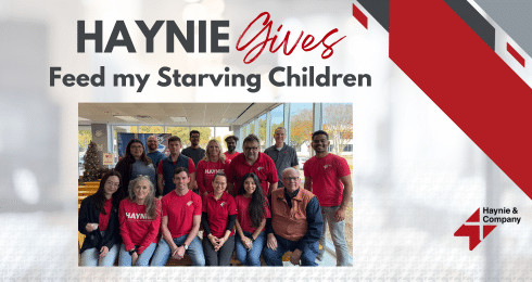Haynie team participates in Feed My Starving Children charity event, group photo in red shirts.