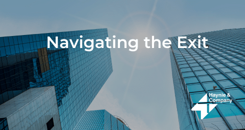 Navigating the Exit text on skyscraper background with Haynie logo.