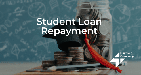 Student Loan Repayment concept with coins and graduation cap.