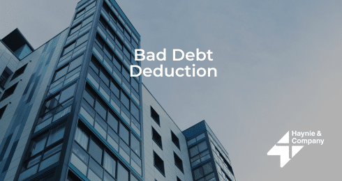 Modern building with Bad Debt Deduction text and Haynie logo in the corner.