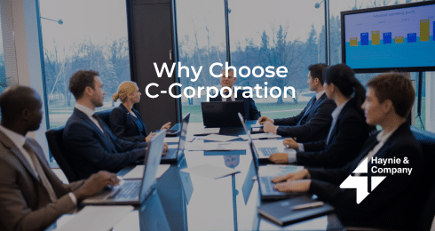 Business meeting discussing C-Corporation benefits.