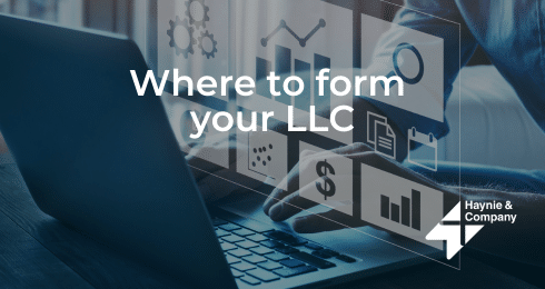 Where to form your LLC text on image of person using a laptop with business icons.