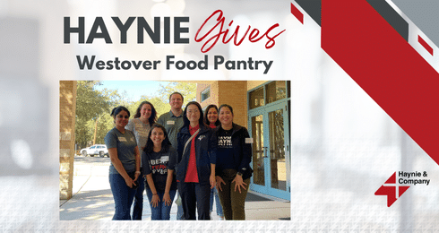 Group of seven people volunteering at Westover Food Pantry, smiling outdoors.