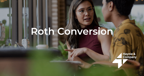 Two people discussing Roth conversion, Haynie branding visible.
