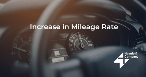 Steering wheel and speedometer with Increase in Mileage Rate text by Haynie.