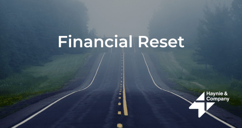 Open road with Financial Reset text overlay and Haynie logo on a foggy day.