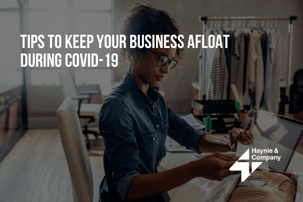 Woman sewing at desk with COVID-19 business tips text overlay.