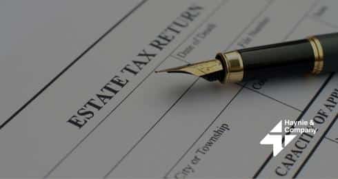 Pen resting on estate tax return document, Haynie logo visible.