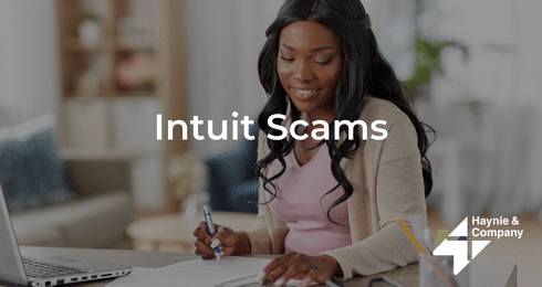 A woman writing notes at a desk with Intuit Scams text overlay, Haynie logo visible.