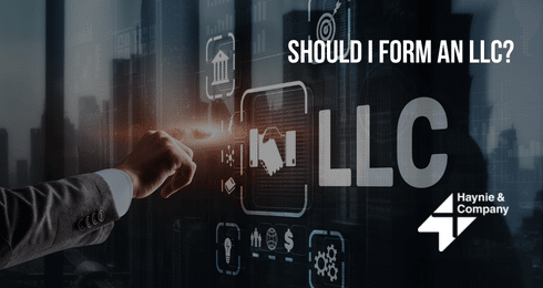 Businessperson interacting with digital LLC interface, Should I Form an LLC? text displayed.