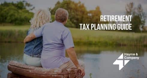 Retirement tax planning guide with couple sitting by a pond.