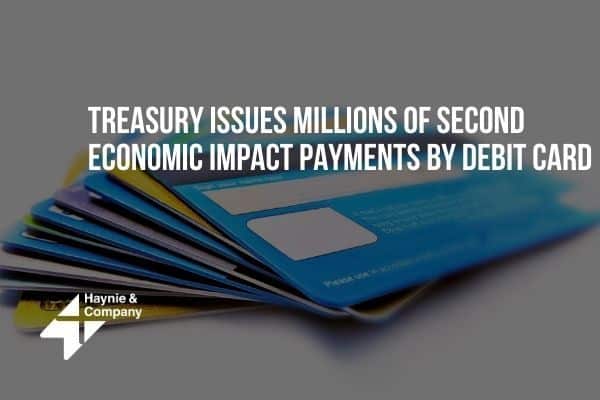 Debit cards with text: Treasury issues millions of second economic impact payments.