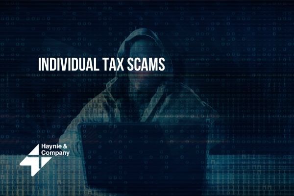Hooded figure at computer with Individual Tax Scams text overlay.