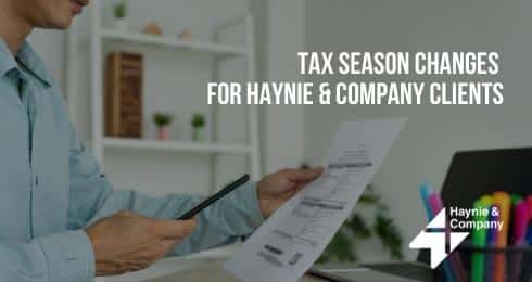 Tax season changes for Haynie clients; person holding a calculator and financial document.