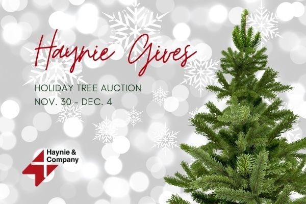 Haynie Gives holiday tree auction poster with pine tree and snowflakes, Nov. 30 - Dec. 4 by Haynie.
