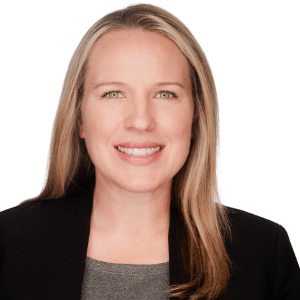 A woman smiling in a professional headshot against a white background.