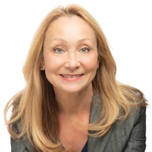 A woman with long blonde hair smiling in a professional headshot.
